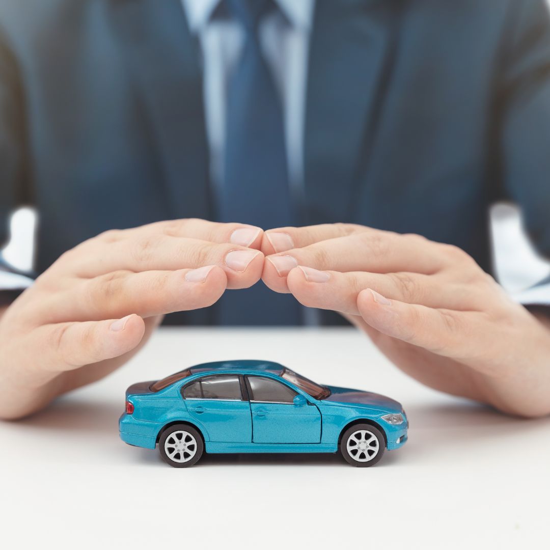 hands covering a toy car